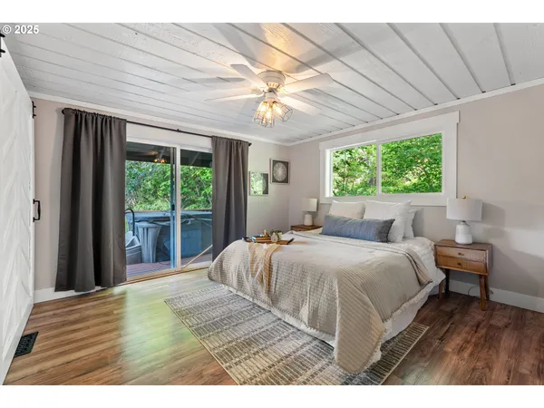 a bedroom with a large bed and a chandelier
