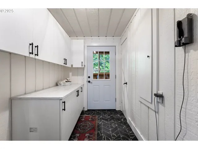 a kitchen with a sink appliances and cabinets