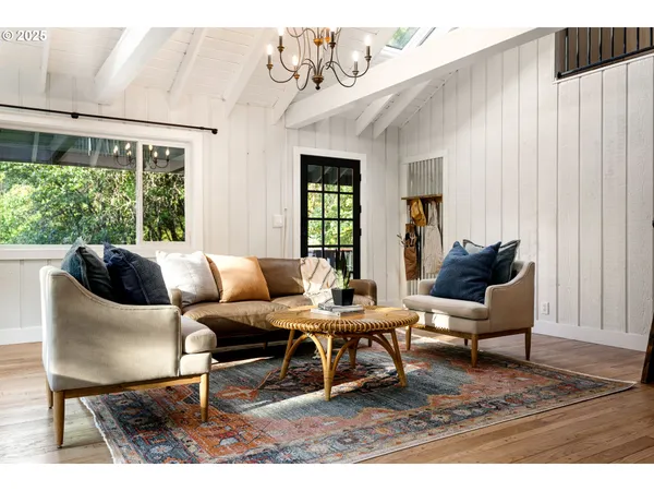 a living room with furniture a window and a table