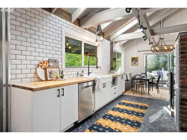 a open kitchen with granite countertop a sink and white cabinets