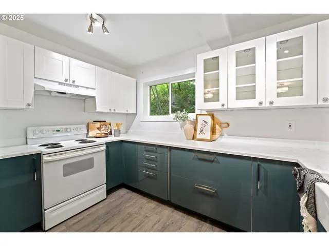 a kitchen with a sink window and cabinets