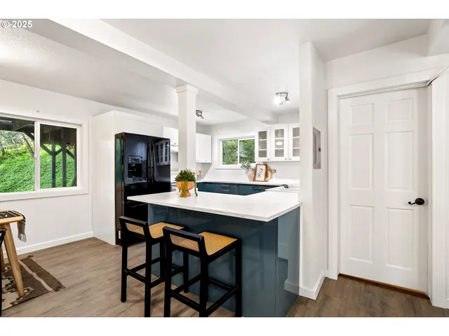 a kitchen with a table and chairs