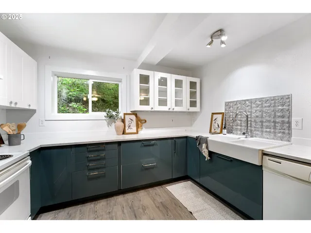 a kitchen with a sink and large window