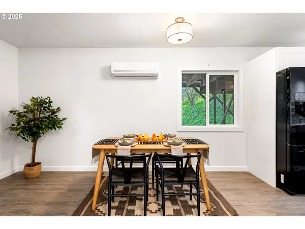 a dining room with furniture and wooden floor