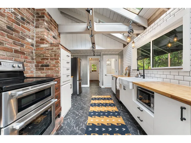 a kitchen with stainless steel appliances granite countertop a stove and a sink