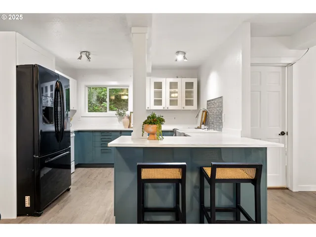a kitchen with stainless steel appliances a sink stove and refrigerator