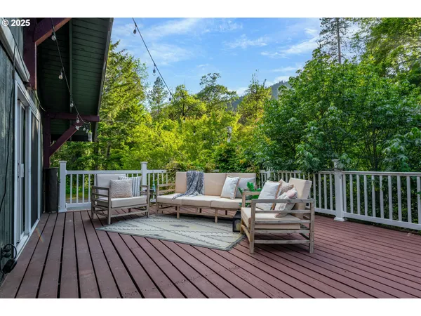 a view of deck with table and chairs and wooden floor