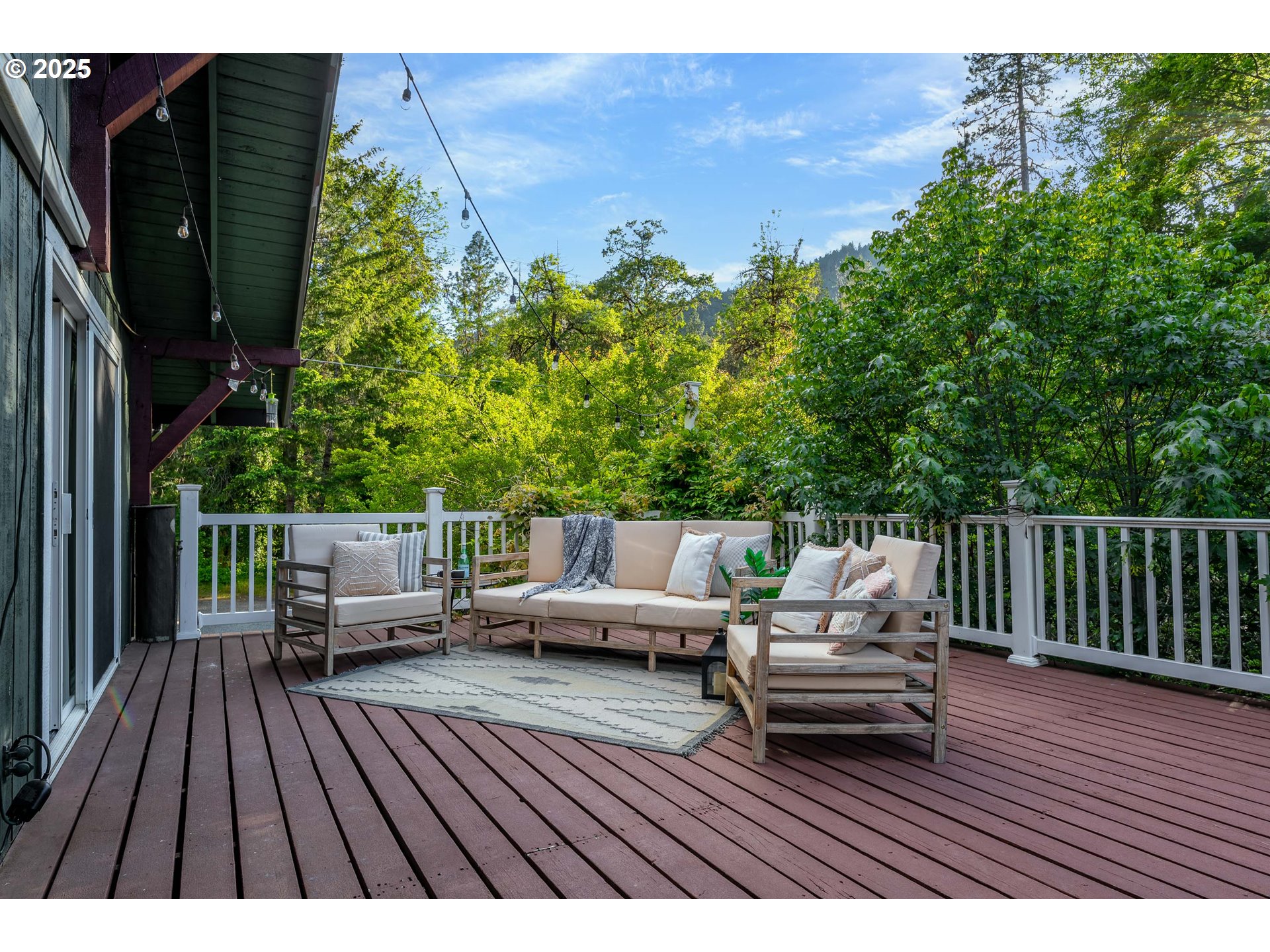 988 Savage Creek Road Grants Pass, OR 97527 - Photo 41 of 48 a view of deck with table and chairs and wooden floor
