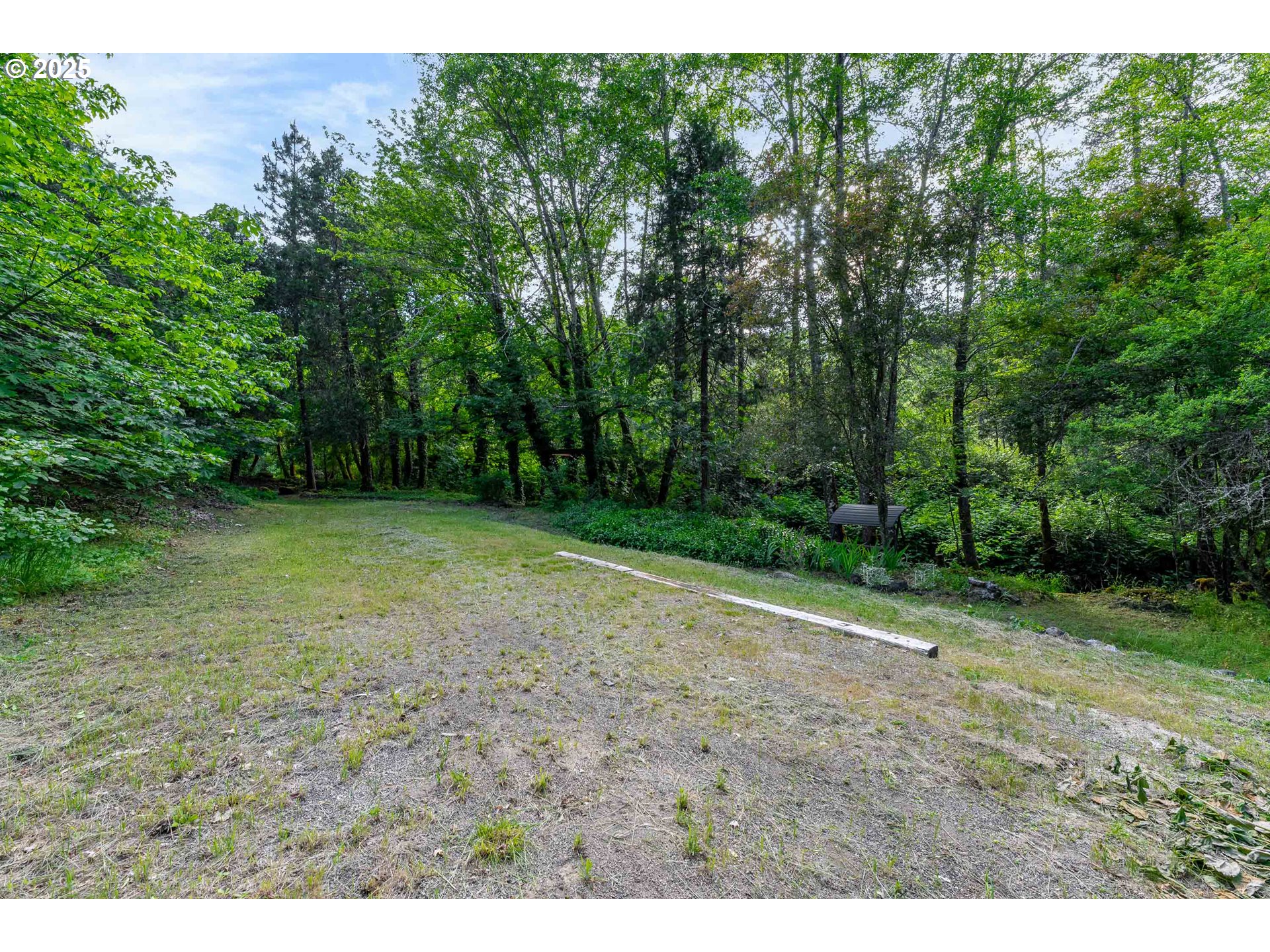 988 Savage Creek Road Grants Pass, OR 97527 - Photo 46 of 48 a view of a yard with a tree