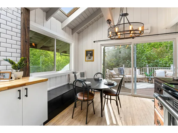 a dining room with furniture a chandelier and wooden floor