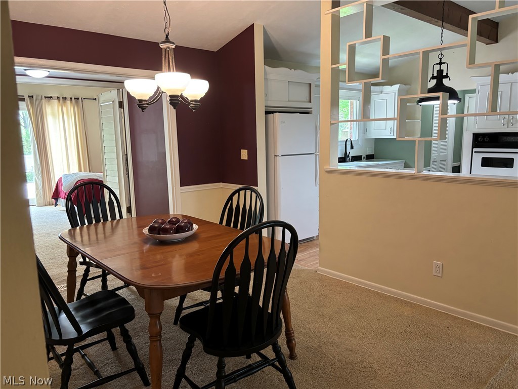 5595 Meister Road Mentor, OH 44060 - Photo 5 of 26 Dining room with light colored carpet and a notable chandelier