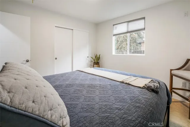 a bedroom with a bed and a window