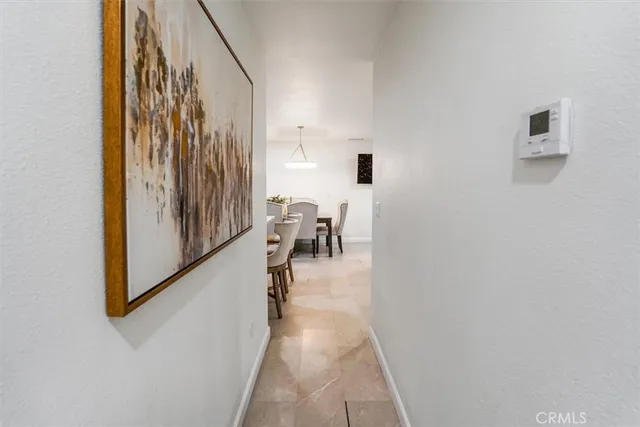 a kitchen with white cabinets and appliances