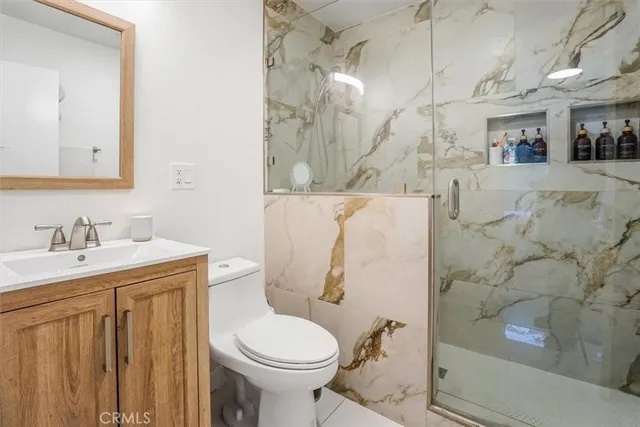 a bathroom with a sink toilet and shower