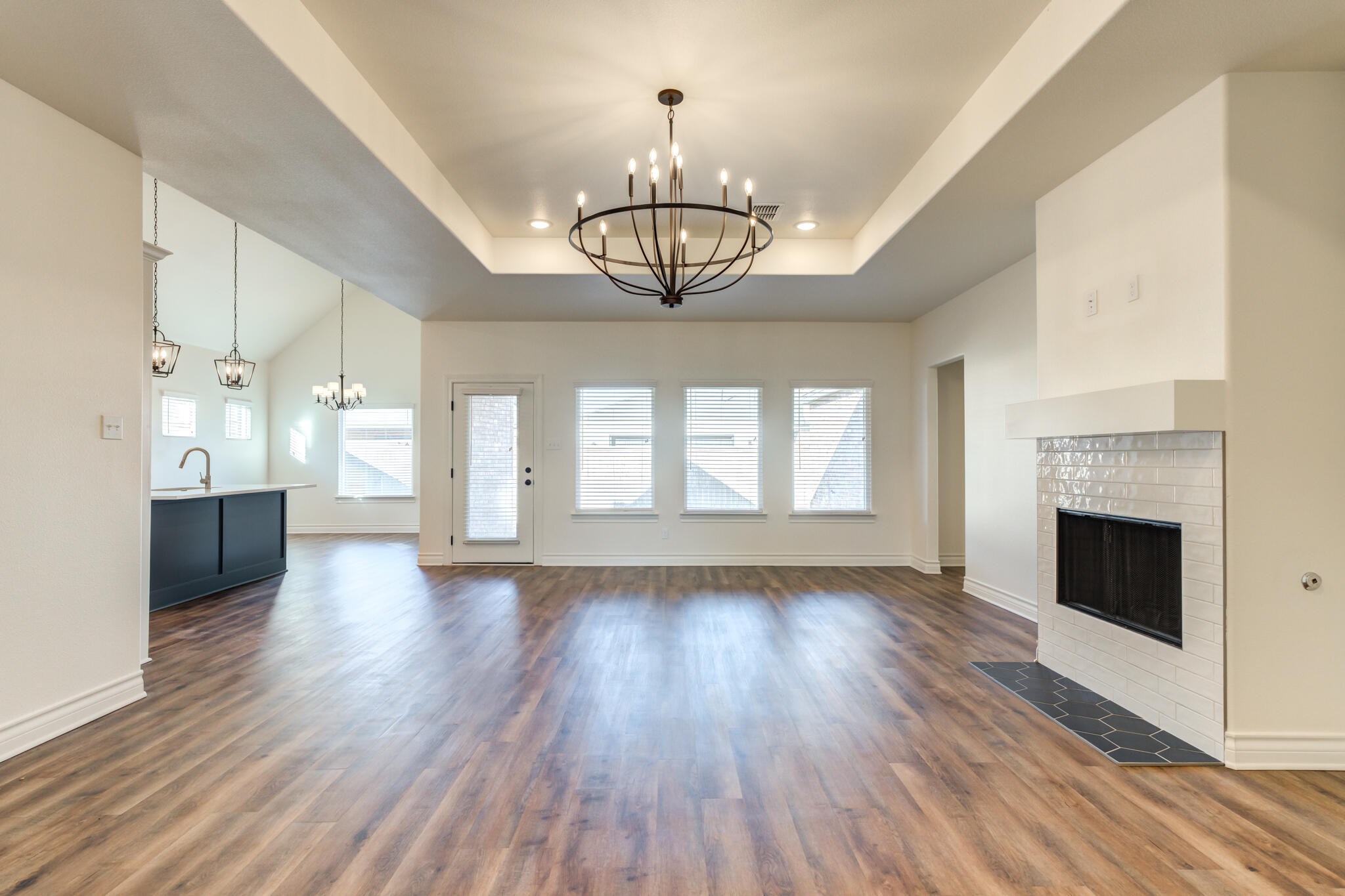 3710 144th Street Lubbock, TX 79423 - Photo 13 of 53 a view of an empty room with wooden floor a fireplace and a window