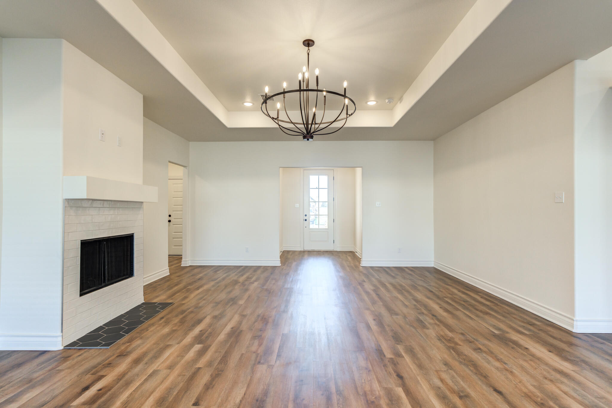3710 144th Street Lubbock, TX 79423 - Photo 16 of 53 a view of empty room with wooden floor fireplace and window