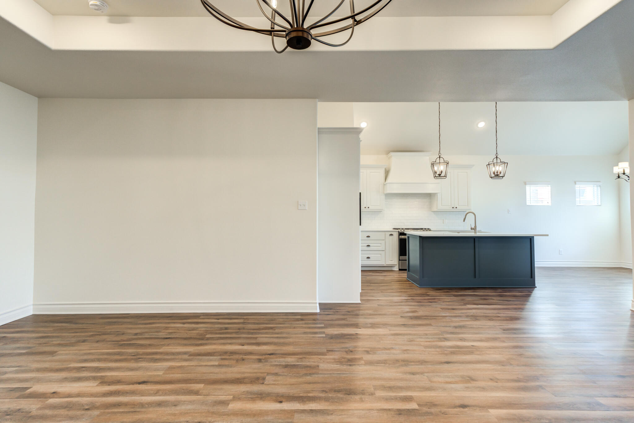 3710 144th Street Lubbock, TX 79423 - Photo 18 of 53 a view of kitchen and empty room with wooden floor