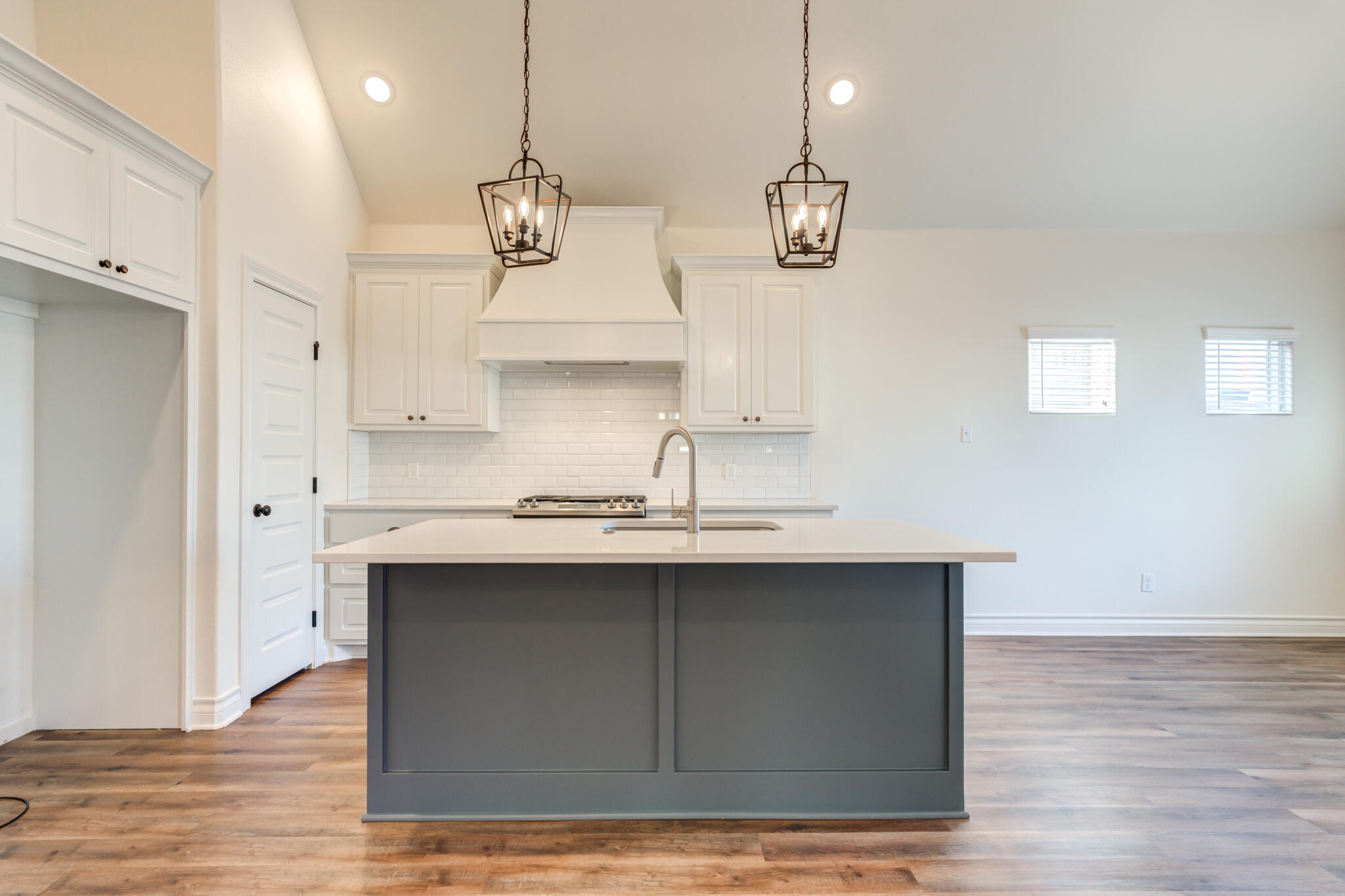 3710 144th Street Lubbock, TX 79423 - Photo 20 of 53 a kitchen with a sink cabinets and wooden floor