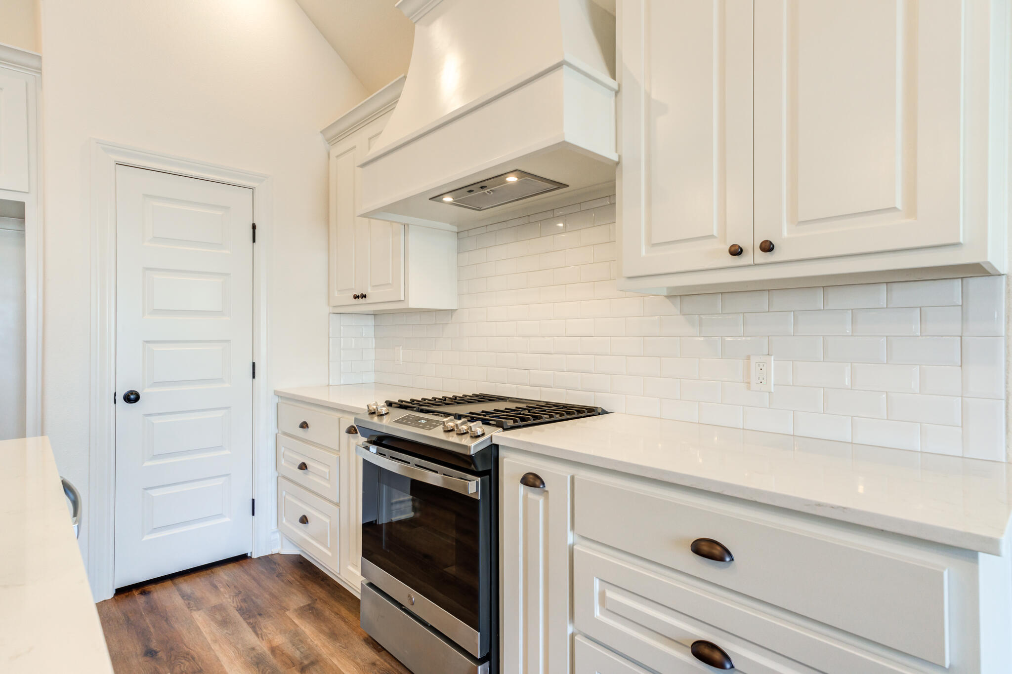 3710 144th Street Lubbock, TX 79423 - Photo 24 of 53 a kitchen with white cabinets and white appliances