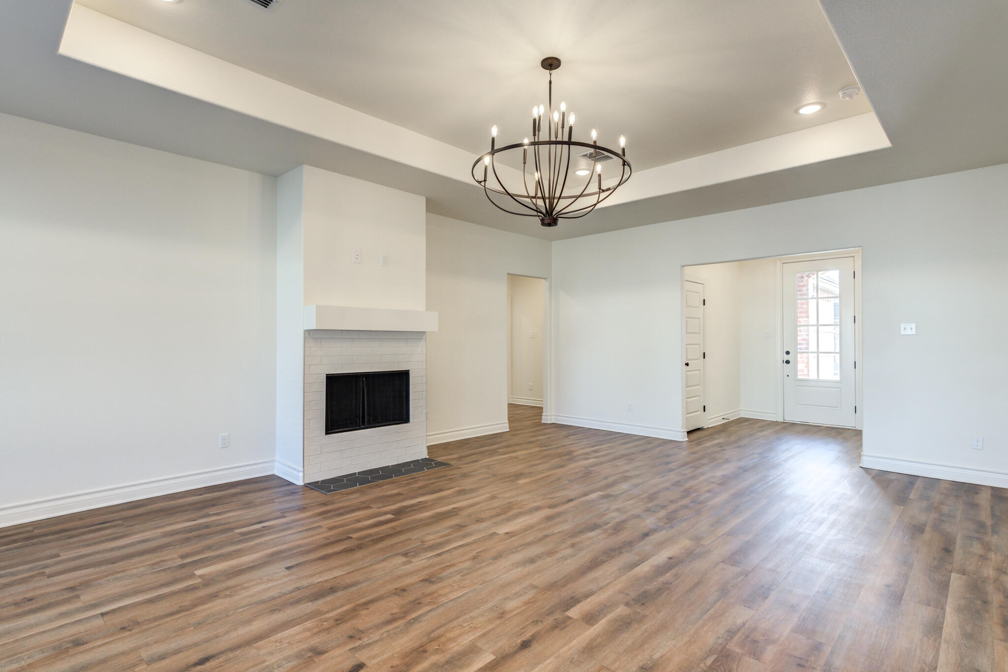 3710 144th Street Lubbock, TX 79423 - Photo 3 of 53 a view of empty room with wooden floor and chandelier