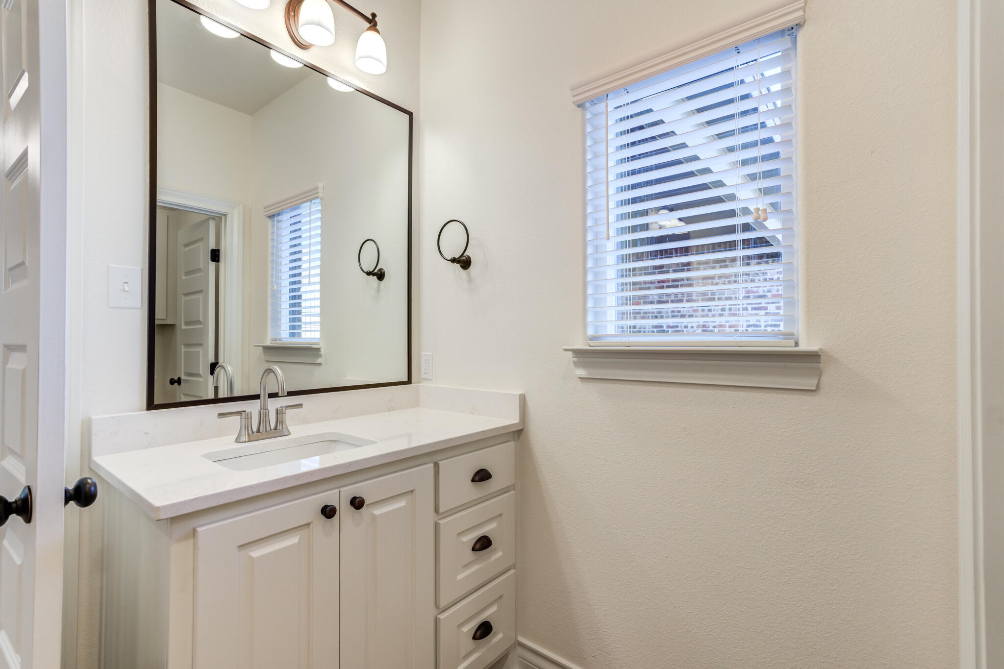 3710 144th Street Lubbock, TX 79423 - Photo 32 of 53 a bathroom with a sink and a mirror