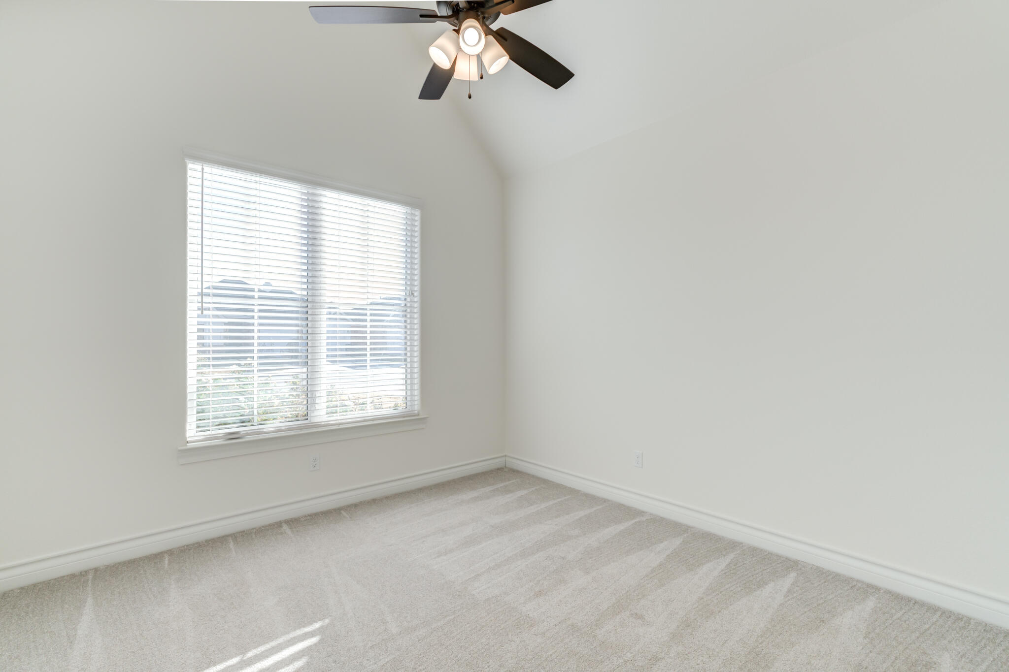 3710 144th Street Lubbock, TX 79423 - Photo 37 of 53 an empty room with a window and a fan