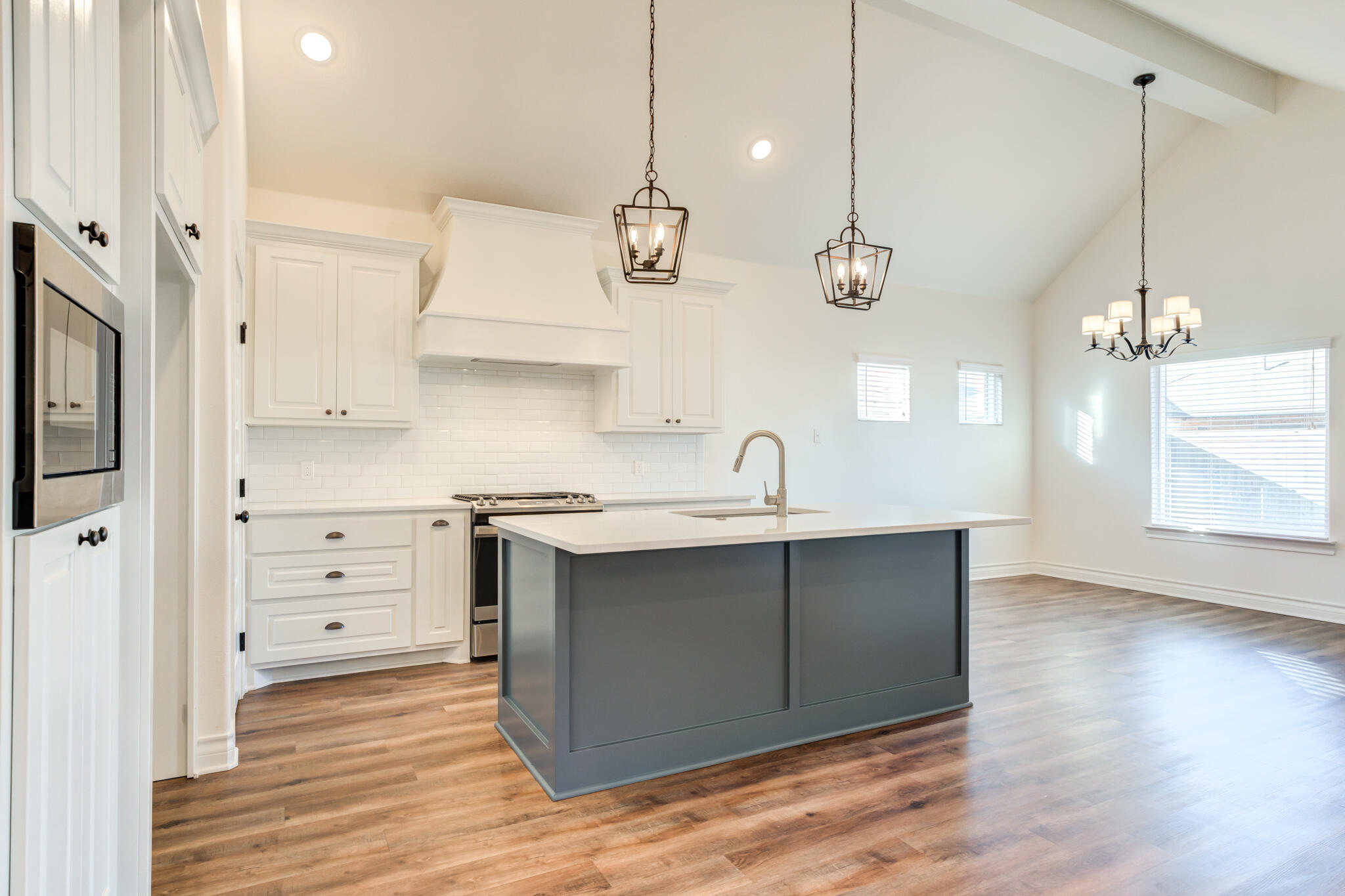 3710 144th Street Lubbock, TX 79423 - Photo 5 of 53 a kitchen with a sink a stove cabinets and wooden floor