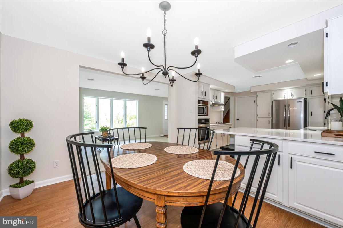 13449 Edgemont Road Smithsburg, MD 21783 - Photo 12 of 70 a view of a dining room with furniture window and wooden floor