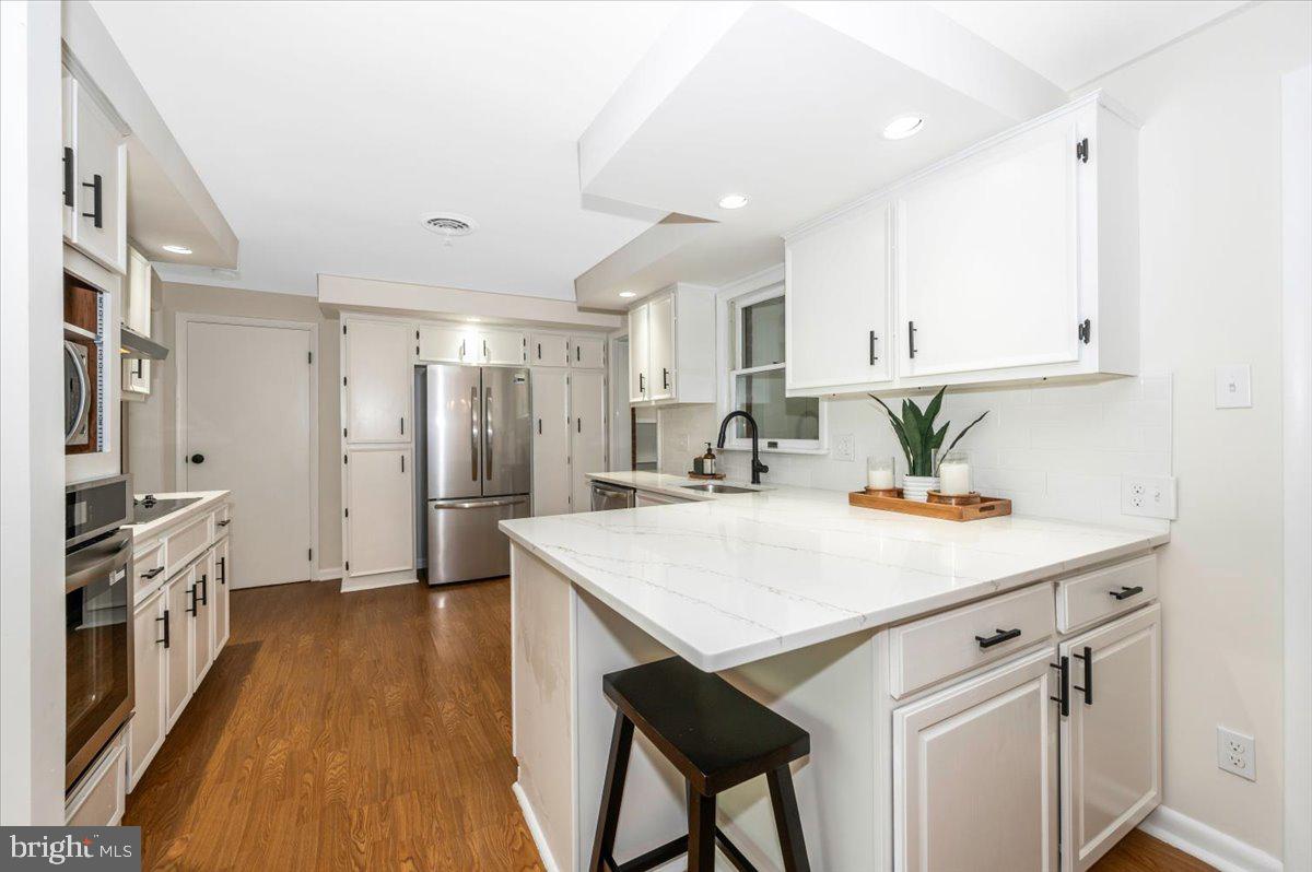 13449 Edgemont Road Smithsburg, MD 21783 - Photo 15 of 70 a kitchen with a table chairs refrigerator and cabinets