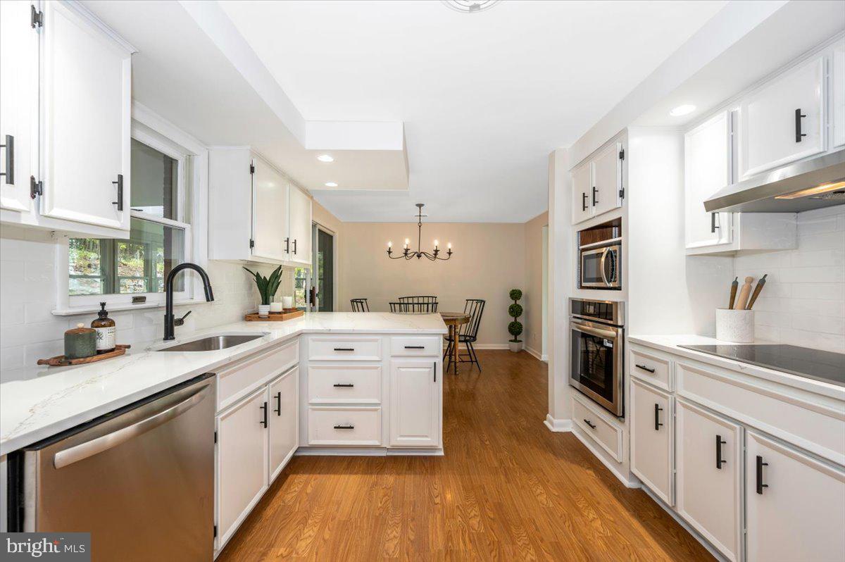 13449 Edgemont Road Smithsburg, MD 21783 - Photo 19 of 70 a kitchen with stainless steel appliances a stove sink and cabinets