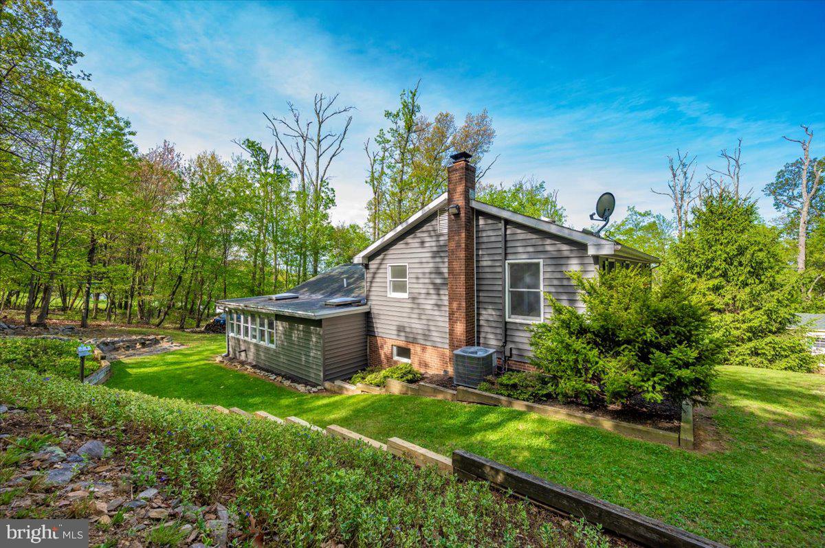 13449 Edgemont Road Smithsburg, MD 21783 - Photo 51 of 70 a view of a house with backyard and a garden