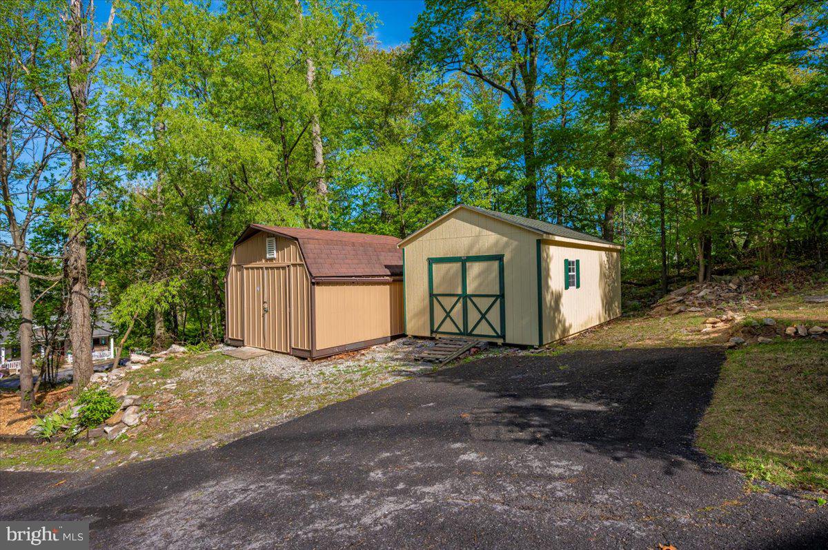 13449 Edgemont Road Smithsburg, MD 21783 - Photo 64 of 70 a front view of a house with a yard and large tree