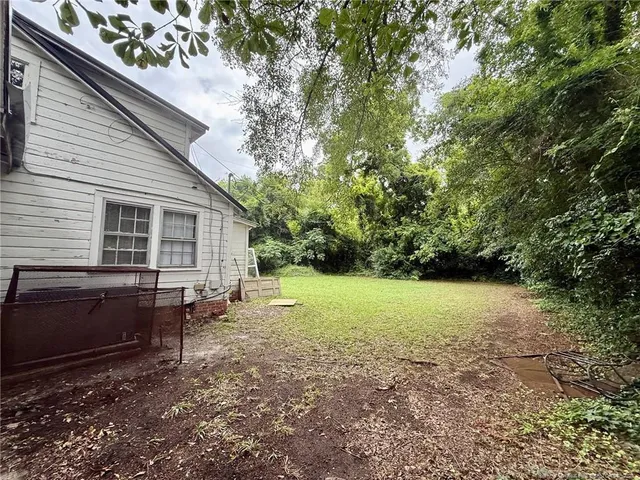 a view of house with backyard space and garden