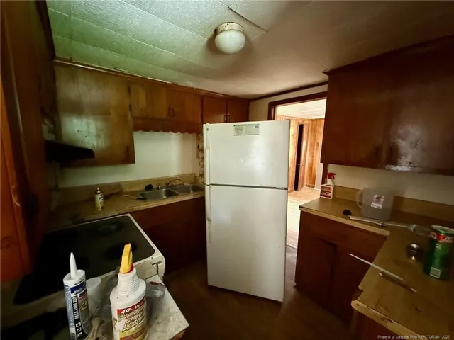 a kitchen with a refrigerator and a stove