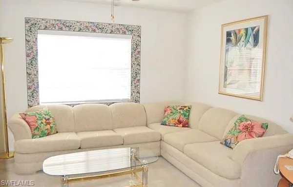 a living room with a couch and a window