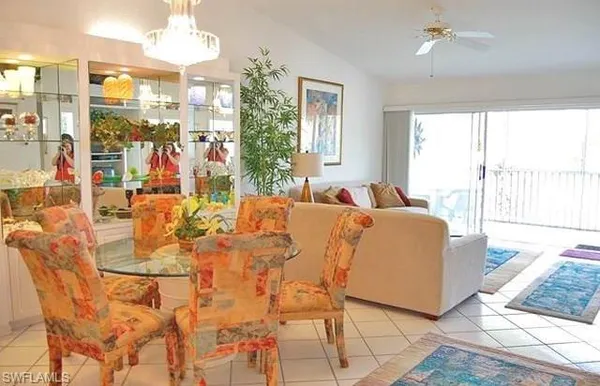 a living room with patio furniture and a large window