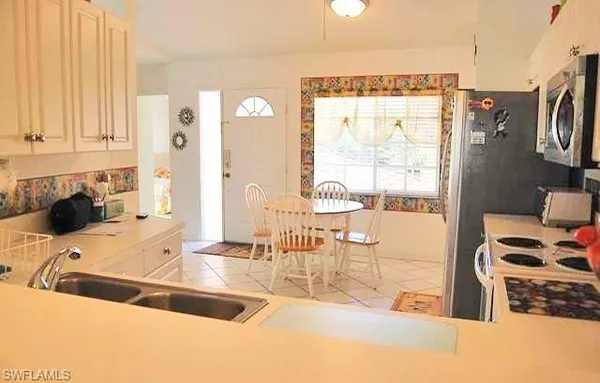 a kitchen with a sink a stove and a refrigerator
