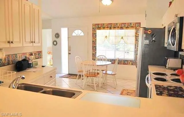 a kitchen with a sink a stove and a refrigerator