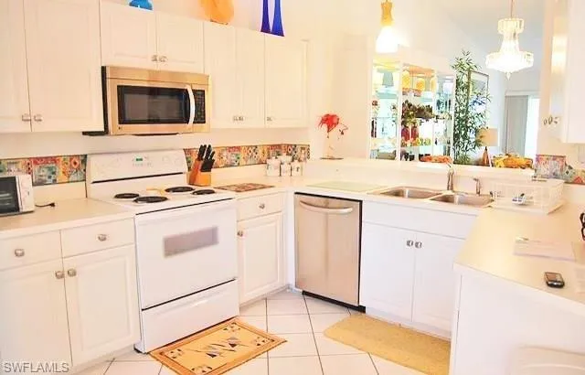 a kitchen with appliances a sink and a counter top space