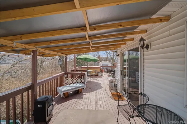 a view of balcony with chairs and wooden fence