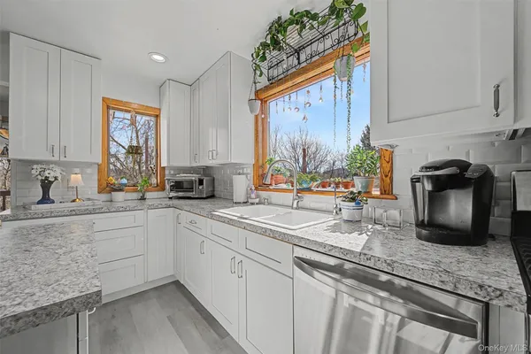 a kitchen with stainless steel appliances granite countertop a sink stove and cabinets