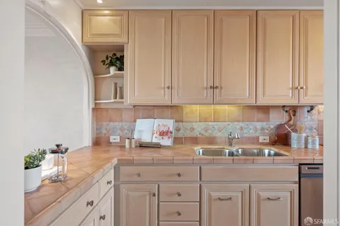 a kitchen with white cabinets and a sink