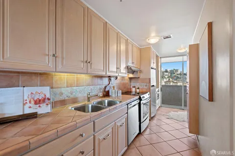 a kitchen with sink cabinets and window