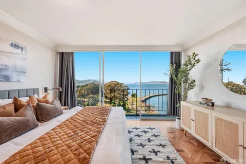 a bedroom with a large bed and a window