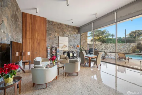 a living room with furniture and flowers