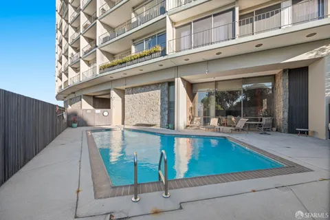 a view of a swimming pool with a lounge chairs