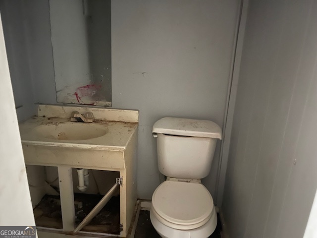 1427 Woodland Road Thomaston, GA 30286 - Photo 10 of 16 a white toilet sitting next to a bathroom sink