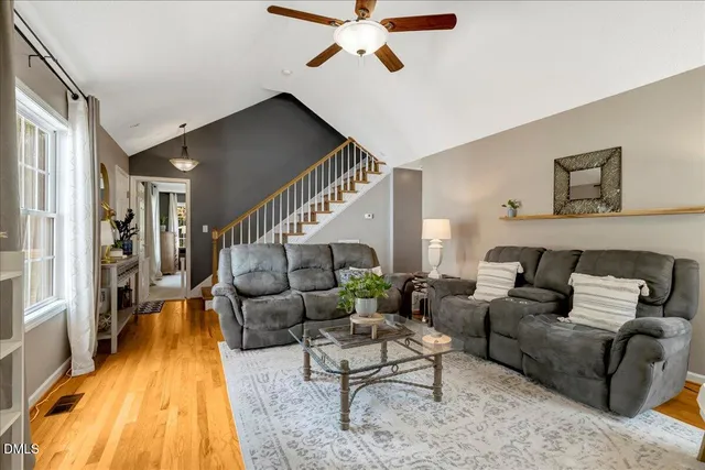 a living room with furniture and a ceiling fan