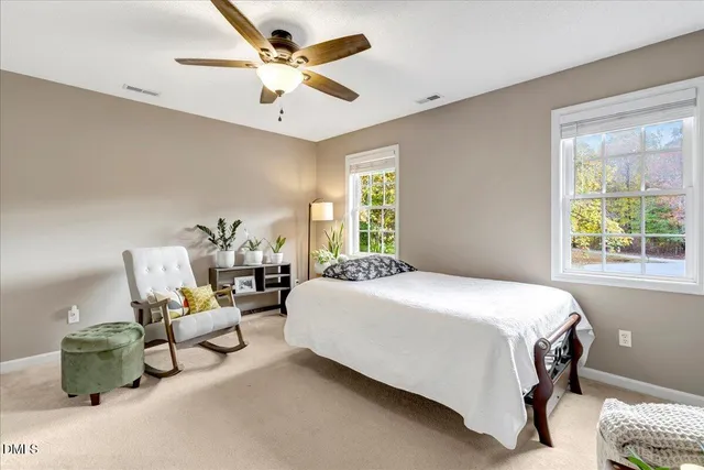 a bedroom with a bed mirror and window