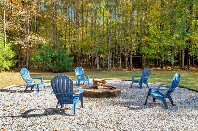 a view of a chairs and bench in the backyard